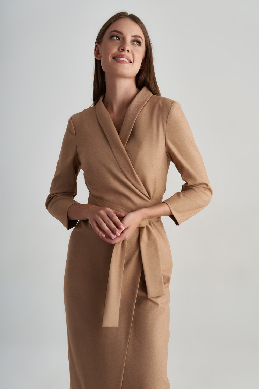 Professional woman in a camel wrap dress