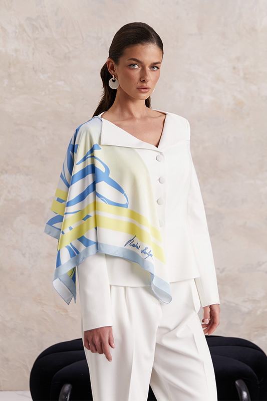 An elegant white Natali Bolgar jacket with trousers and a bold designer scarf for a fresh spring look.