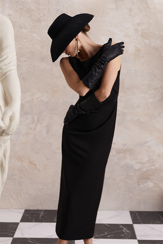 An elegant black Natali Bolgar dress with long gloves and a hat, the perfect evening look for autumn.