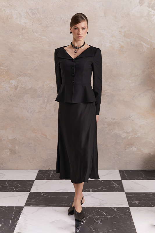 An elegant business look from Natali Bolgar: a black peplum jacket and a black A-line midi skirt.