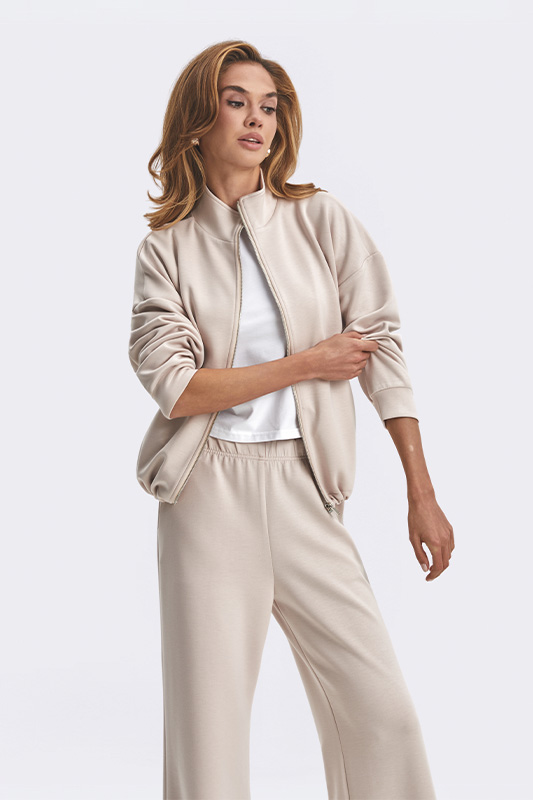 Comfortable women's look by Natali Bolgar for home or leisure: a light beige bomber jacket, white t-shirt, and comfortable wide trousers.