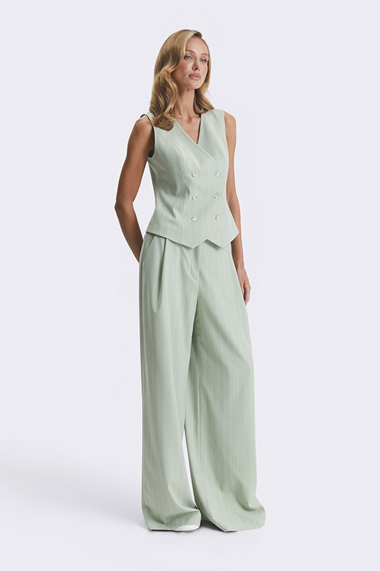 An elegant spring Natali Bolgar look: a women's vest and wide-leg trousers in a pastel green stripe for the office.