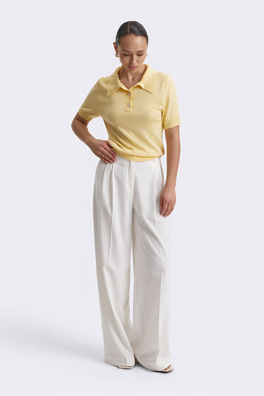 A look from Natali Bolgar: a light yellow short-sleeve polo and elegant wide white trousers. Perfect for the spring-summer season.